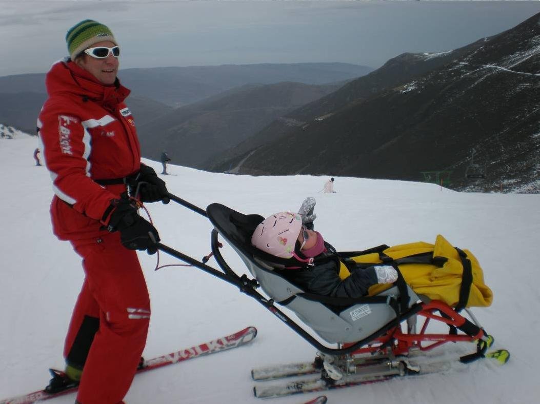 Fotografía de monitor con un niño en dual esquí